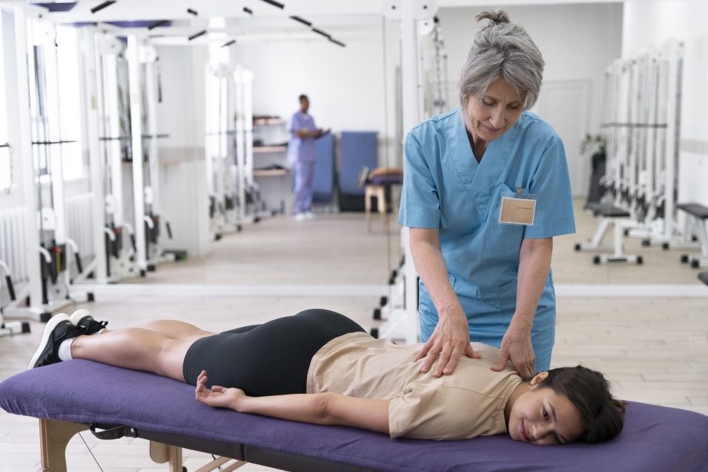 Physiotherapy Cost in Dhaka 6 medical assistant helping patient with physiotherapy exercises 2 Physiotherapy Cost in Dhaka